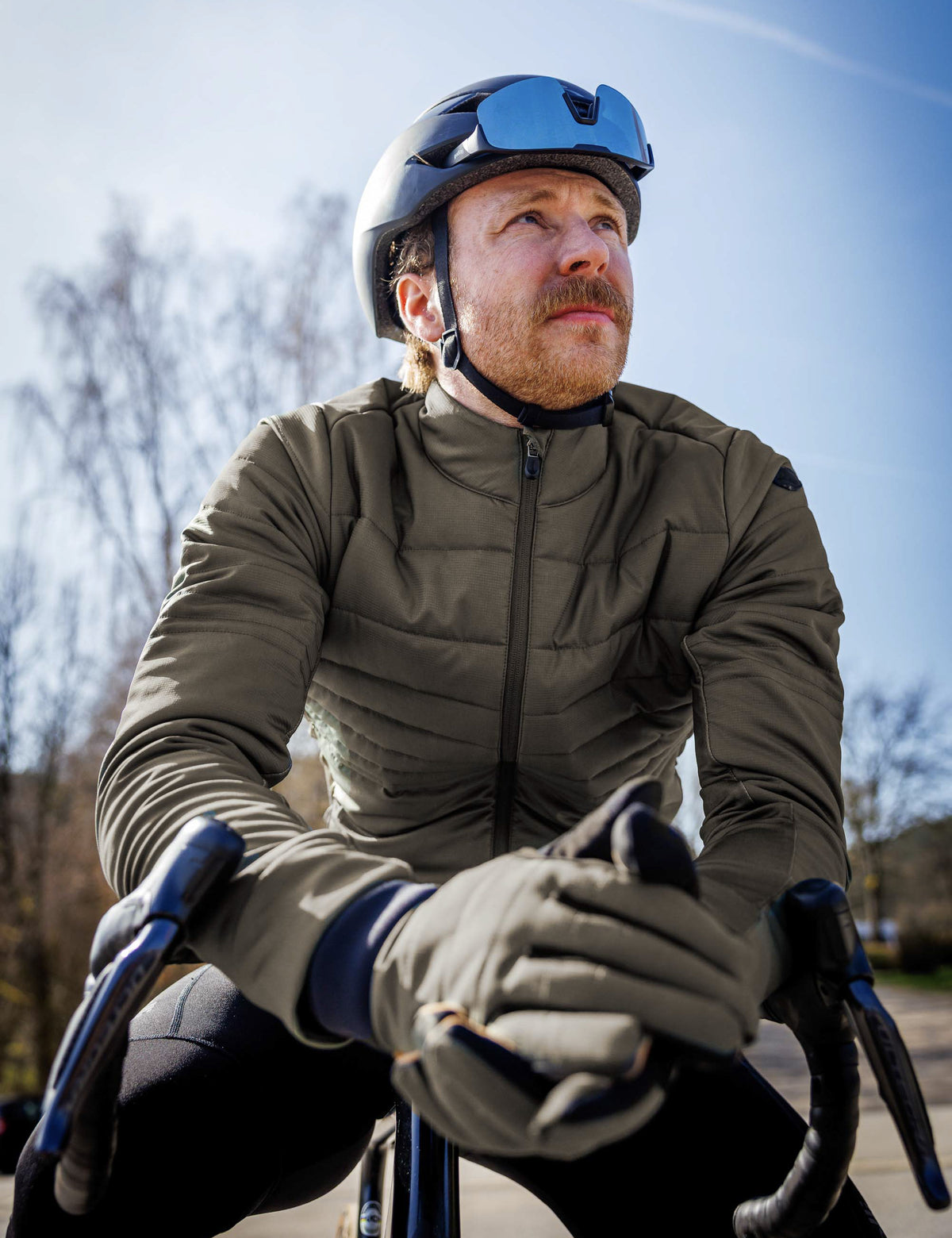 Man in legergroen Rogelli Element winter fietsjack heren tijdens een rit op de racefiets in koud weer.