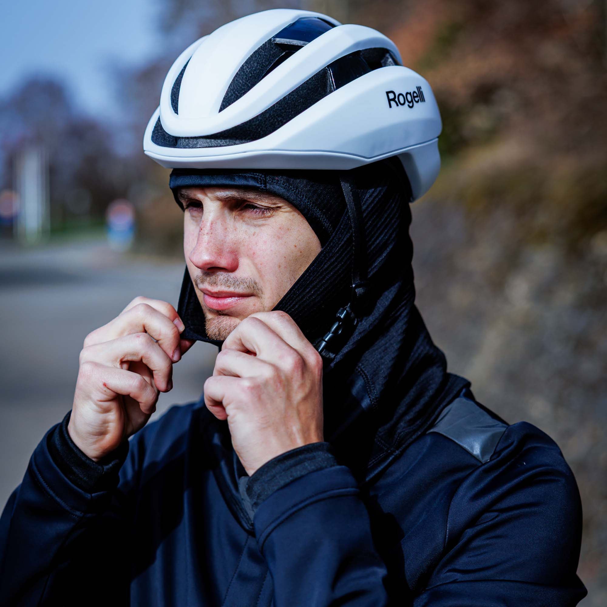 Man met Rogelli fietsaccessoires zoals fietshelm en warme hoofdbedekking voor fietsen in koud weer.