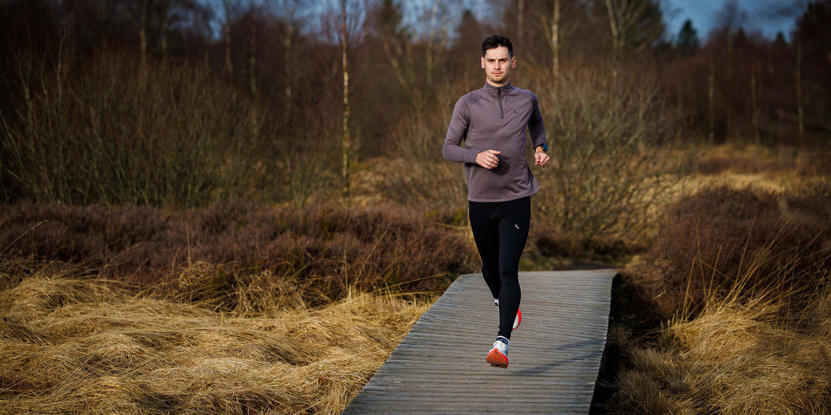 Banner categorie hardlooptops heren. Hardloper in de duinen met een blauwe Rogelli hardlooptop aan.